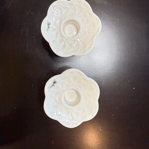 A pair of White Flower-Shaped Candle Holders Oleg Cassini